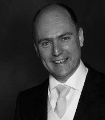 A picture containing person, person, suit, necktie
Description automatically generated